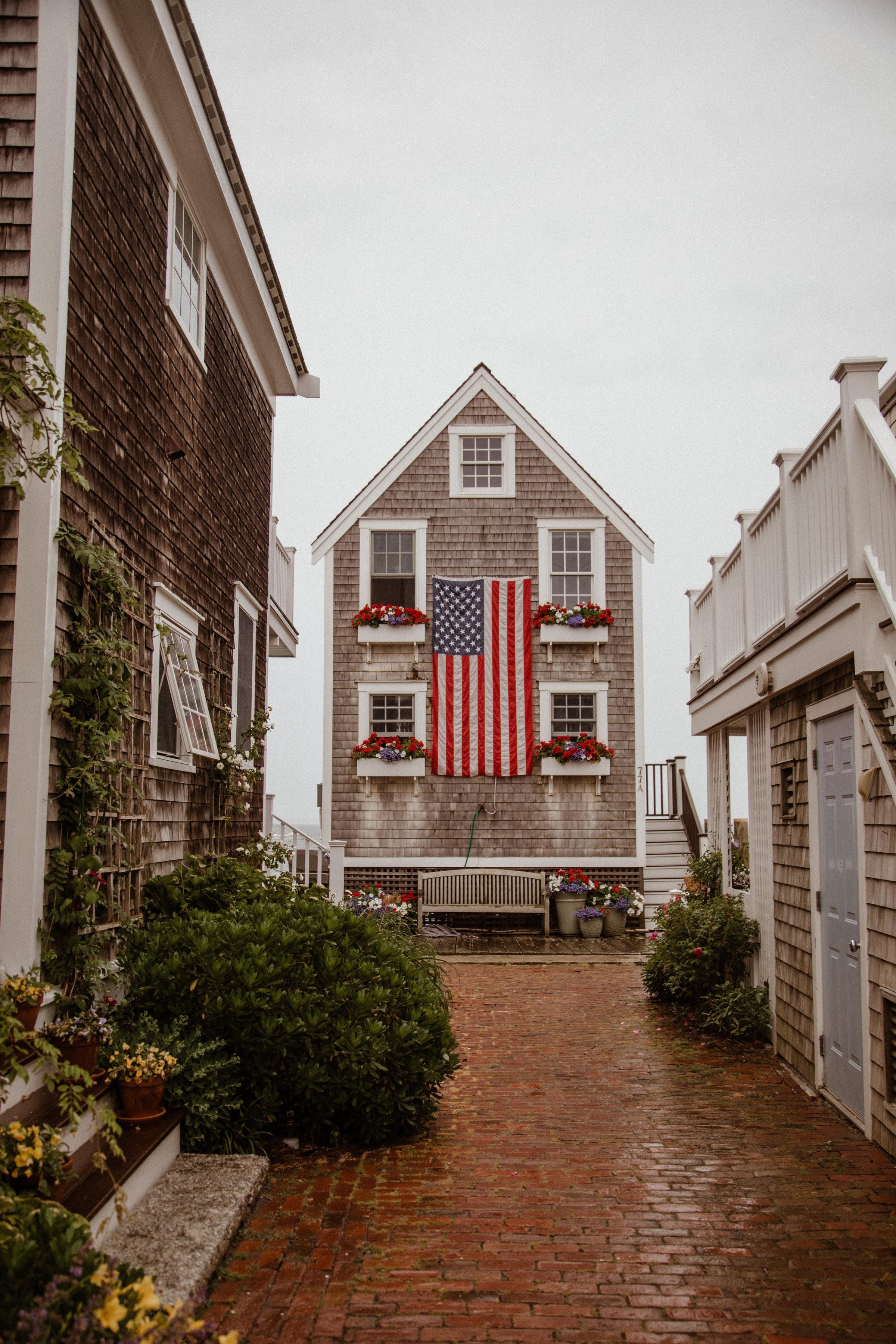 shingle house with large american flag